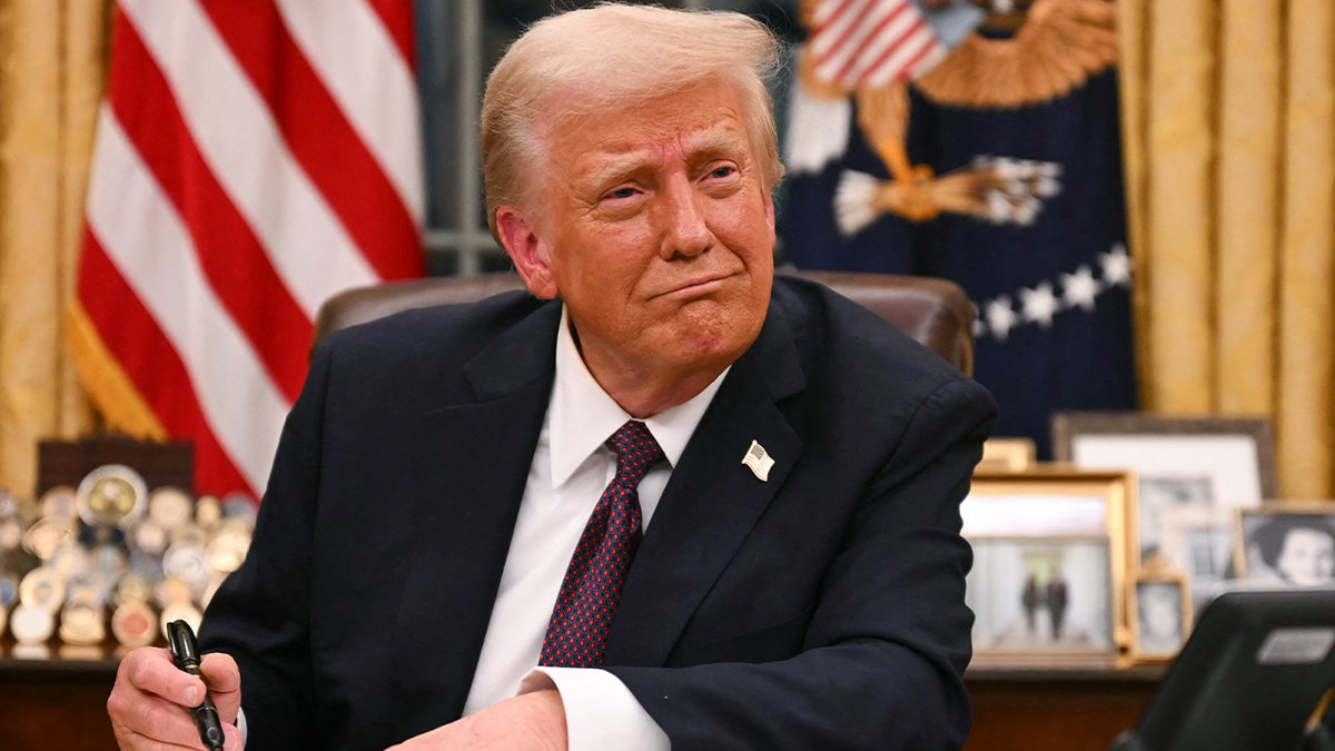 President Trump signs orders in the Oval Office