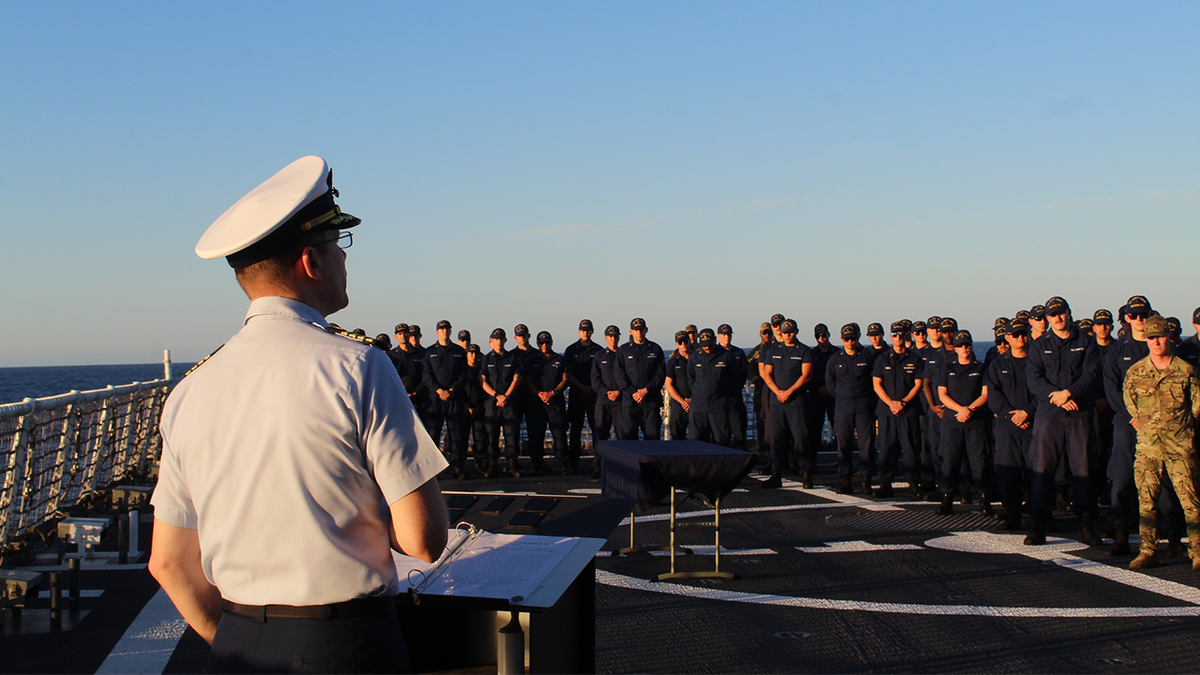 Captain Tyson Scofield, Commanding Officer of USCGC Waesche, pays tribute to Petty Officer 3rd Class Travis 'Obie' Obendorf, a Boatswain’s Mate who served on Waesche in 2013. BM3 Obendorf’s memorial ceremony set aside time for the crew to remember and celebrate the beloved crew member who sacrificed his life serving others.