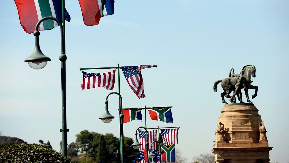 U.S. and South African flags are shown at Union Buildings in Pretoria.