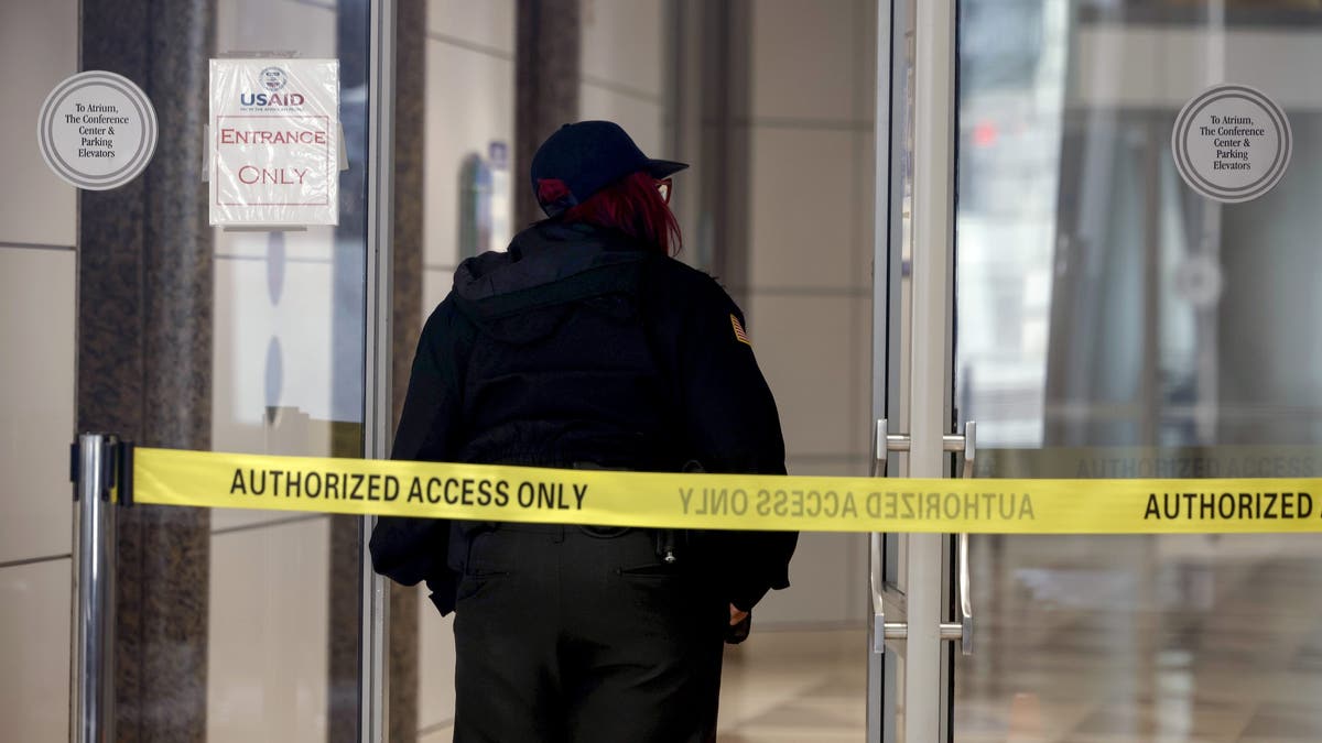 WASHINGTON, DC - FEBRUARY 03: A security guard stands at the entrance to the U.S. Agency for International Development (USAID) headquarters on February 03, 2025 in Washington, DC. Elon Musk, tech billionaire and head of the Department of Government Efficiency (DOGE), said in a social media post that he and U.S. President Doanld Trump will shut down the foreign assistance agency.  (Photo by Kevin Dietsch/Getty Images)