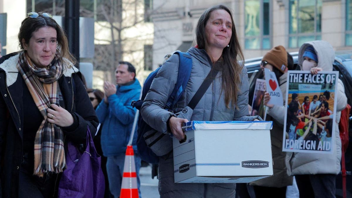 Tears staff leave the US Agency for International Development Building in Washington, DC