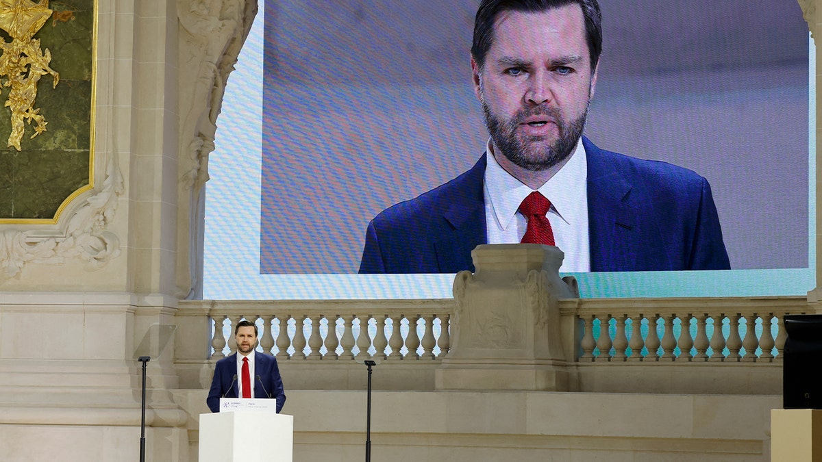 JD Vance speaks on the podium at the Paris AI Summit