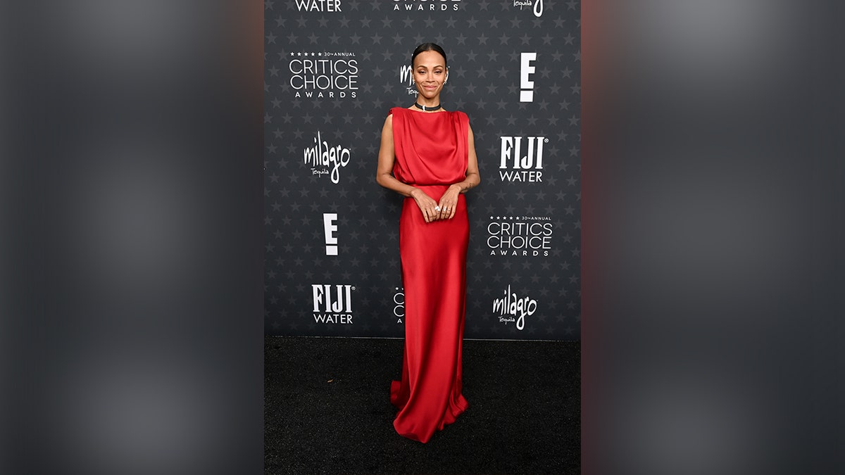 Saldana wore a red dress, which she paired with a black choker and a few rings.