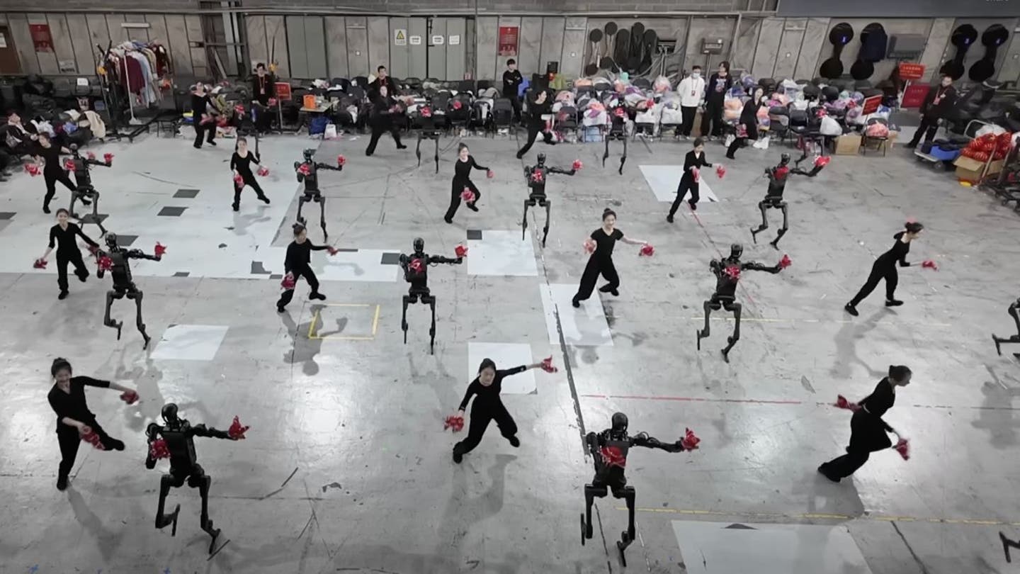 5 humanoid robots bust dance moves alongside humans