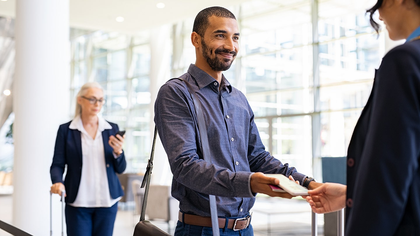 man with gate agent boarding flight