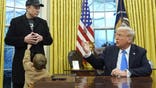 President Donald Trump speaks as Elon Musk, joined by his son X Æ A-Xii, listens in the Oval Office at the White House, Tuesday, Feb. 11, 2025, in Washington. (Photo/Alex Brandon)