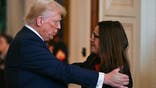 US President Donald Trump embraces Allyson Phillips, mother of Laken Riley, before signing the Laken Riley Act in the East Room of the White House in Washington, DC, January 29, 2025. The Laken Riley Act -- which mandates the detention of undocumented immigrants charged with theft-related crimes -- is named for a 22-year-old student murdered by a Venezuelan man with no papers who was wanted for shoplifting. (Photo by PEDRO UGARTE / AFP) (Photo by PEDRO UGARTE/AFP via Getty Images)