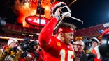 Kansas City Chiefs quarterback Patrick Mahomes taking off his helmet on the field