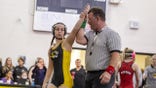 Siena Palmisciano overcame health issues to prove she could be a winner in wrestling. The referee is holding her hand in the air.