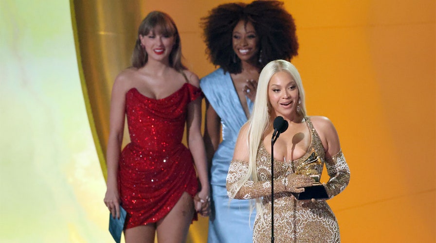 Taylor Swift stuns in a red dress while on the 2025 Grammy Awards red carpet