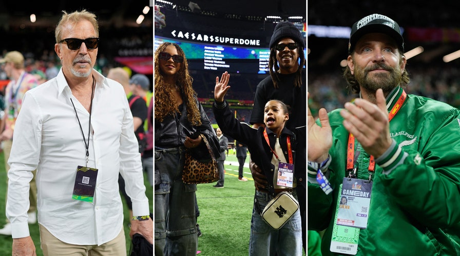 Bradley Cooper standing on the sidelines at the Super Bowl