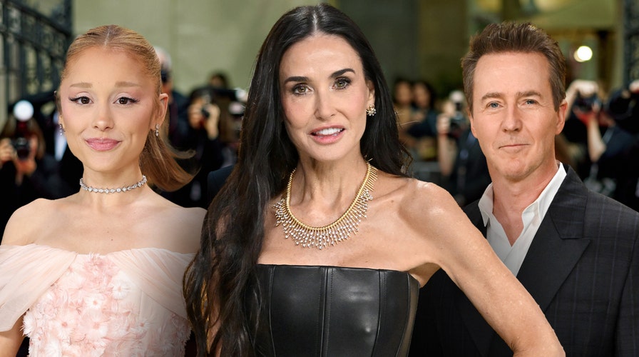 Demi Moore walks the red carpet in a gold dress at the 2025 Golden Globes