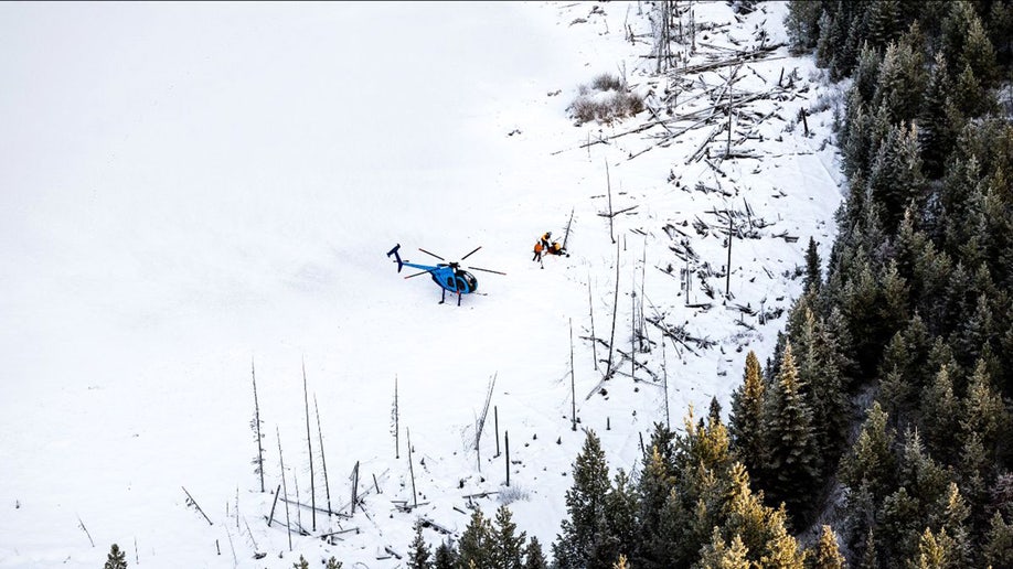 helicopter sits in snowy meadow