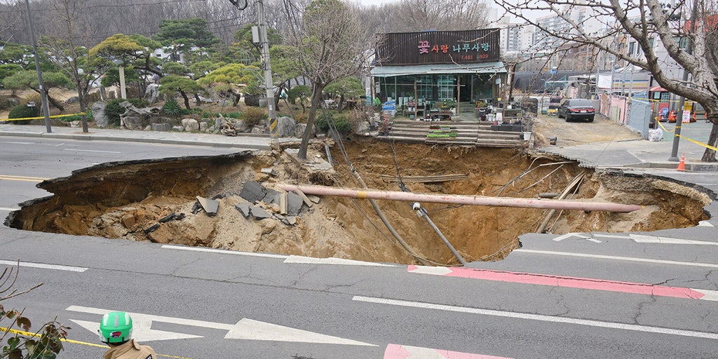 Motorcyclist who disappeared into sinkhole is found dead following