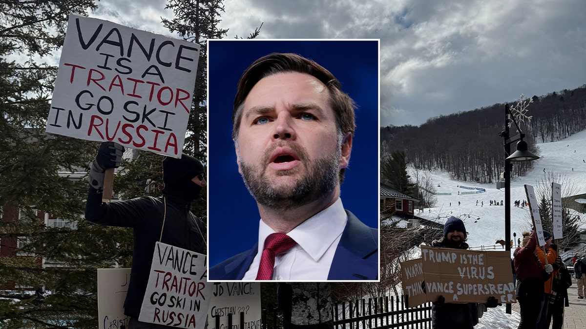 JD Vance is pictured in front of protesters