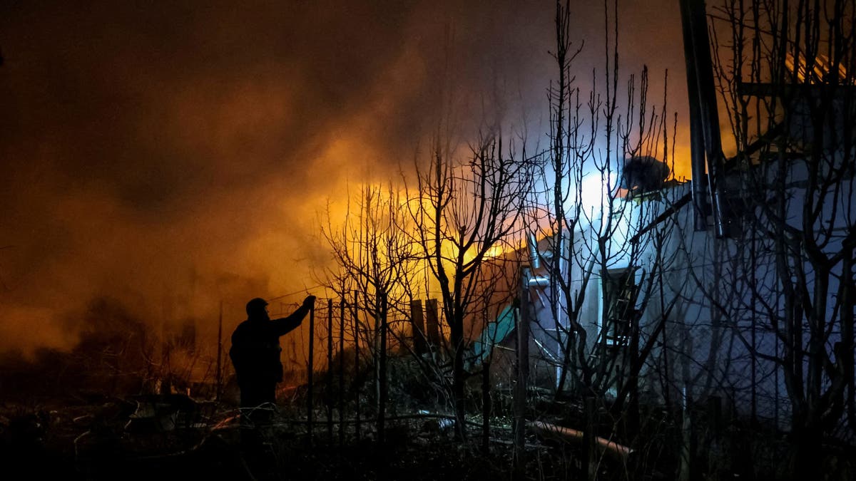 Rescuers work at the site of a building destroyed during a Russian air strike, amid Russia's attack on Ukraine, in Kherson, Ukraine March 14, 2025.