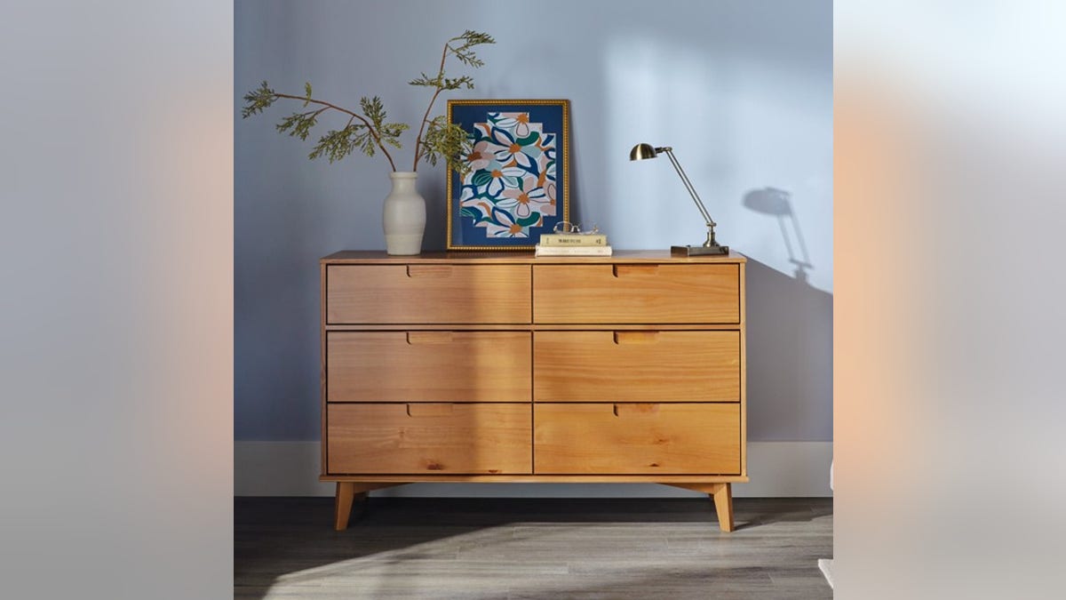 This clean-looking wooden dresser can hold all your clothes.?