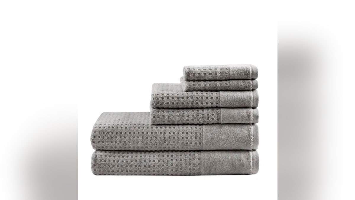 The Madison Park waffle weave towels feature a textured, honeycomb-like pattern that enhances absorbency and speeds up drying.