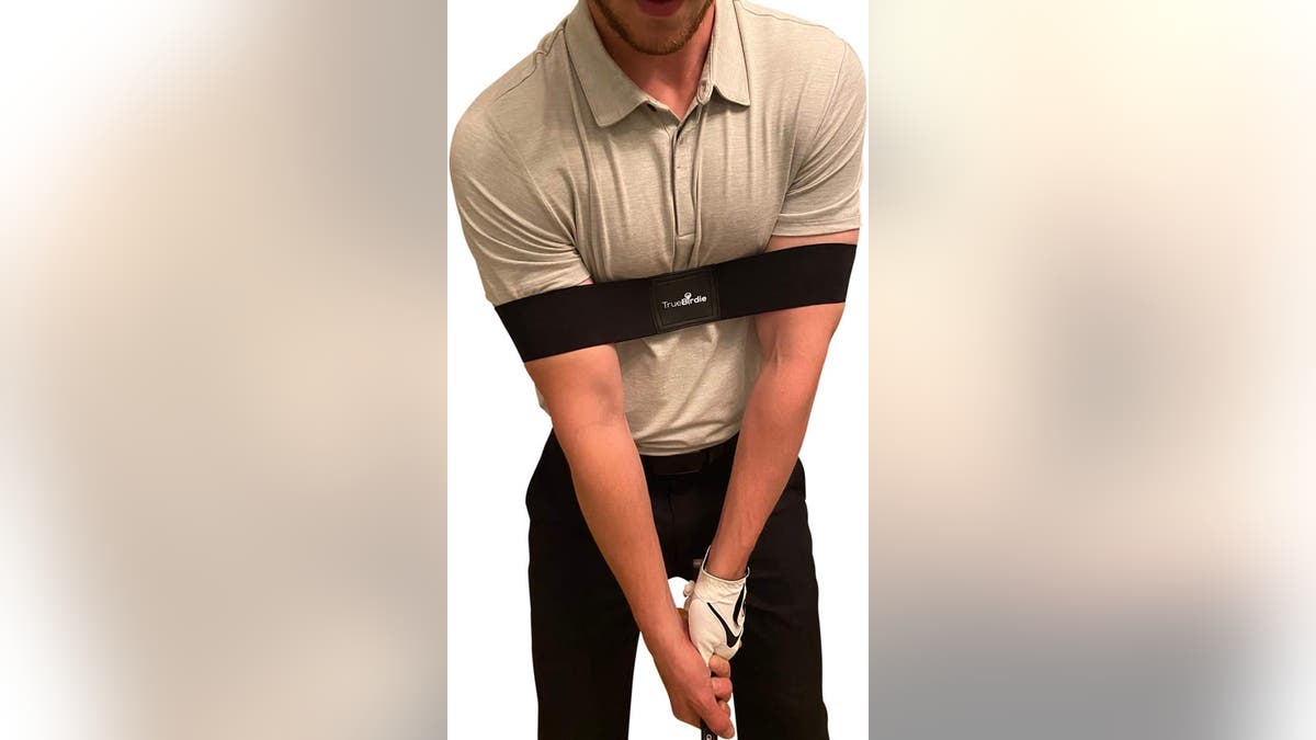 Train your arms and body to swing together with a golf swing training band.