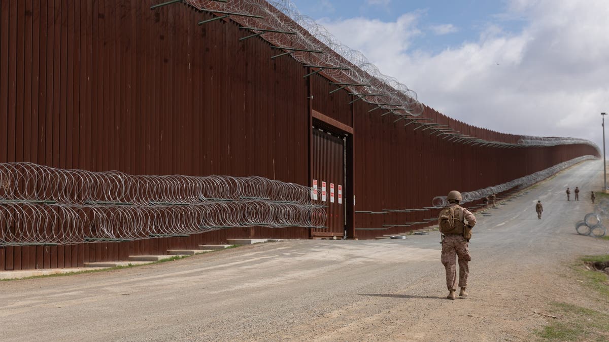 Marine pedestrians along the border wall