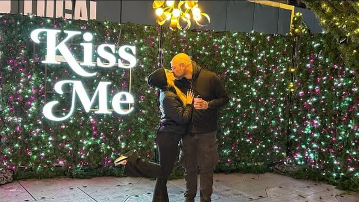 Aaron Goodwin kisses his wife