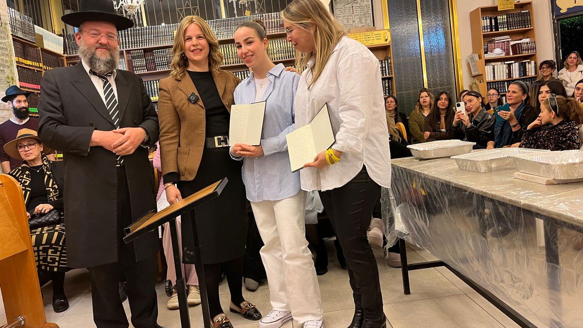 Agam Berger stands with Rabbi Arieh Levin, his wife Rebbetzin Yocheved Levin and her mother Merav at the Yechezkel Synagogue in Israel.