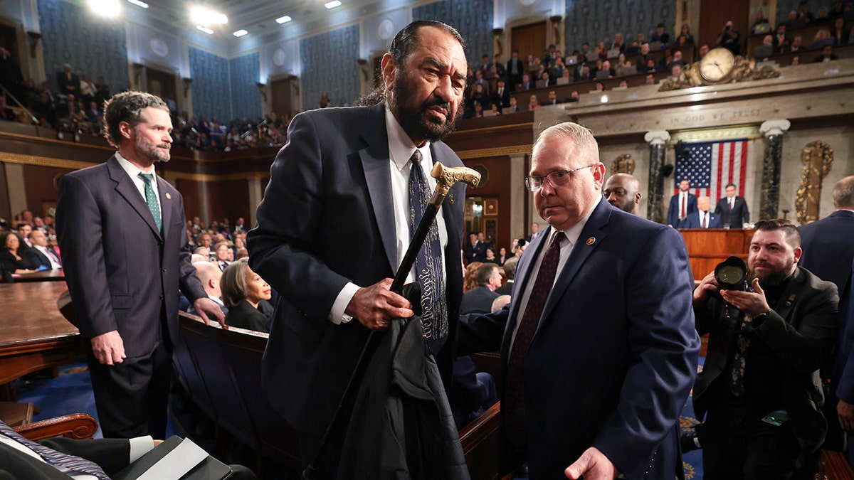 House sergeant-at-arms escorting Al Green from the House chamber