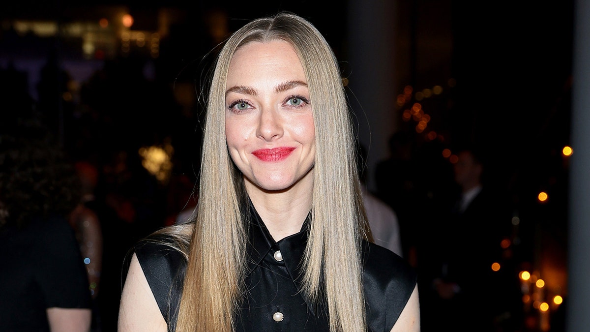 Near Amanda Seyfried smiling with black