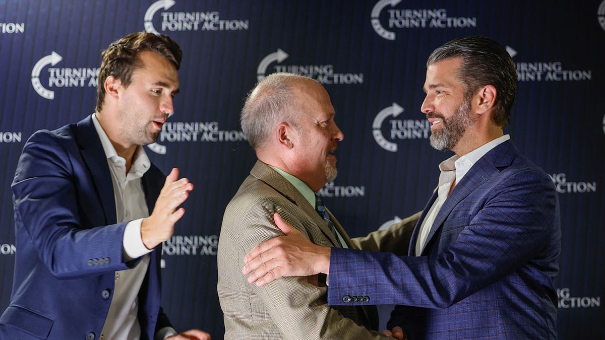 Brad Schimel in between Donald Trump Jr. and Charlie Kirk at event supporting his Wisconsin Supreme Court run