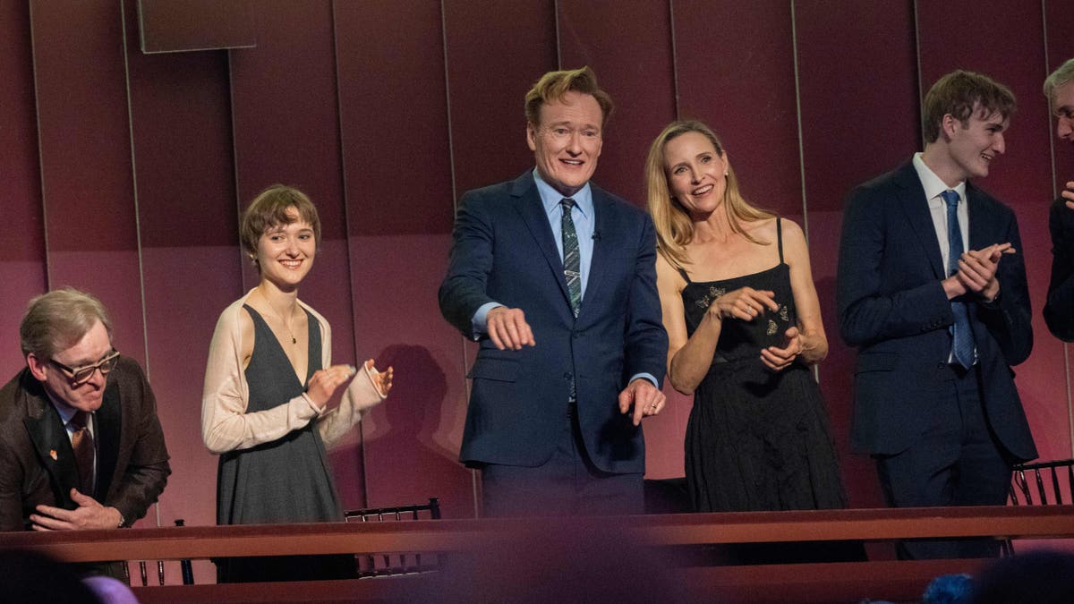 Comedian Conan O'Brien, Centro, and his wife, Liza Powel O'Brien, look at the crowd at the beginning of the 25th Mark Twain Annual Award for the American humor that celebrates Conan O'Brien. 