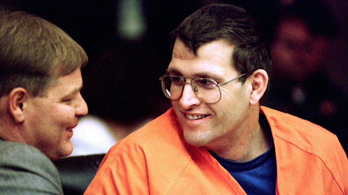 Keith Jesperson smiling wearing an orange jumpsuit.