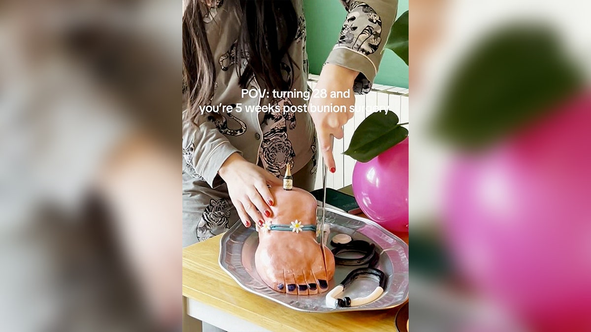 Woman cutting foot bunion cake