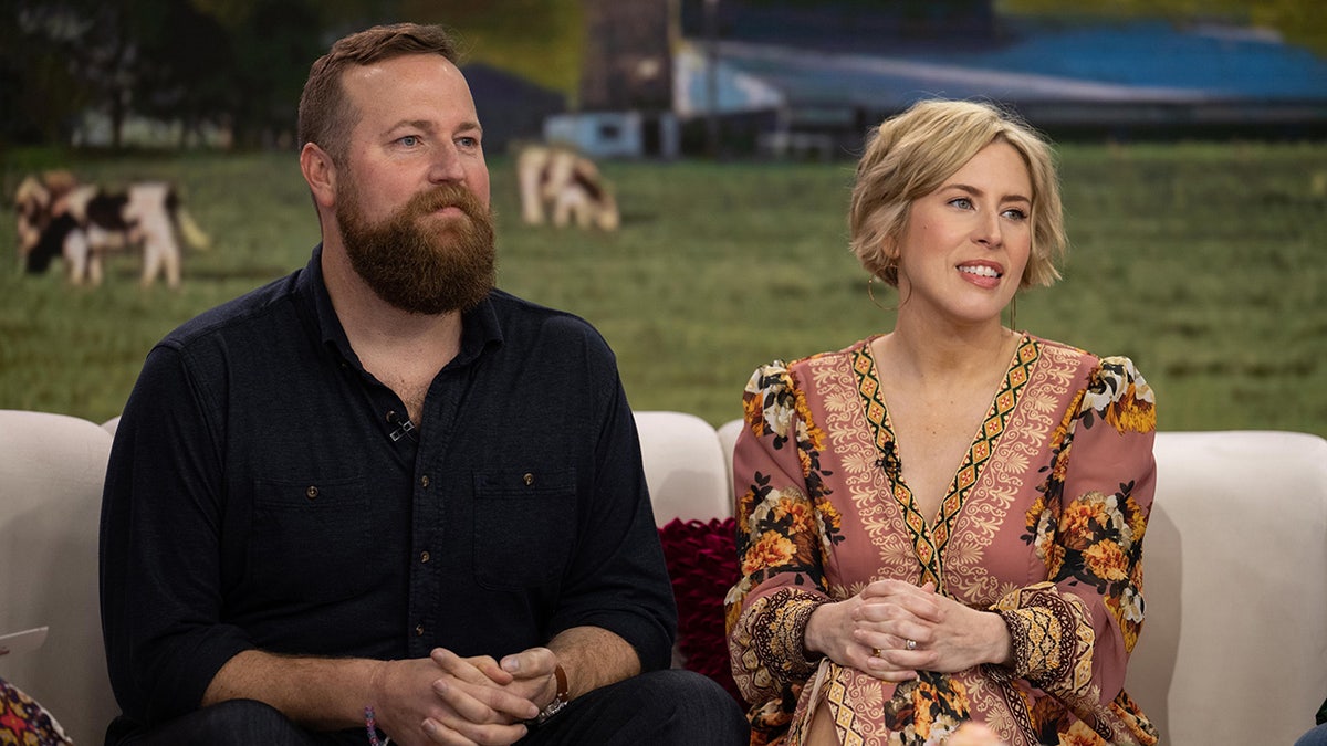 Ben and Erin Napier sitting together on a couch