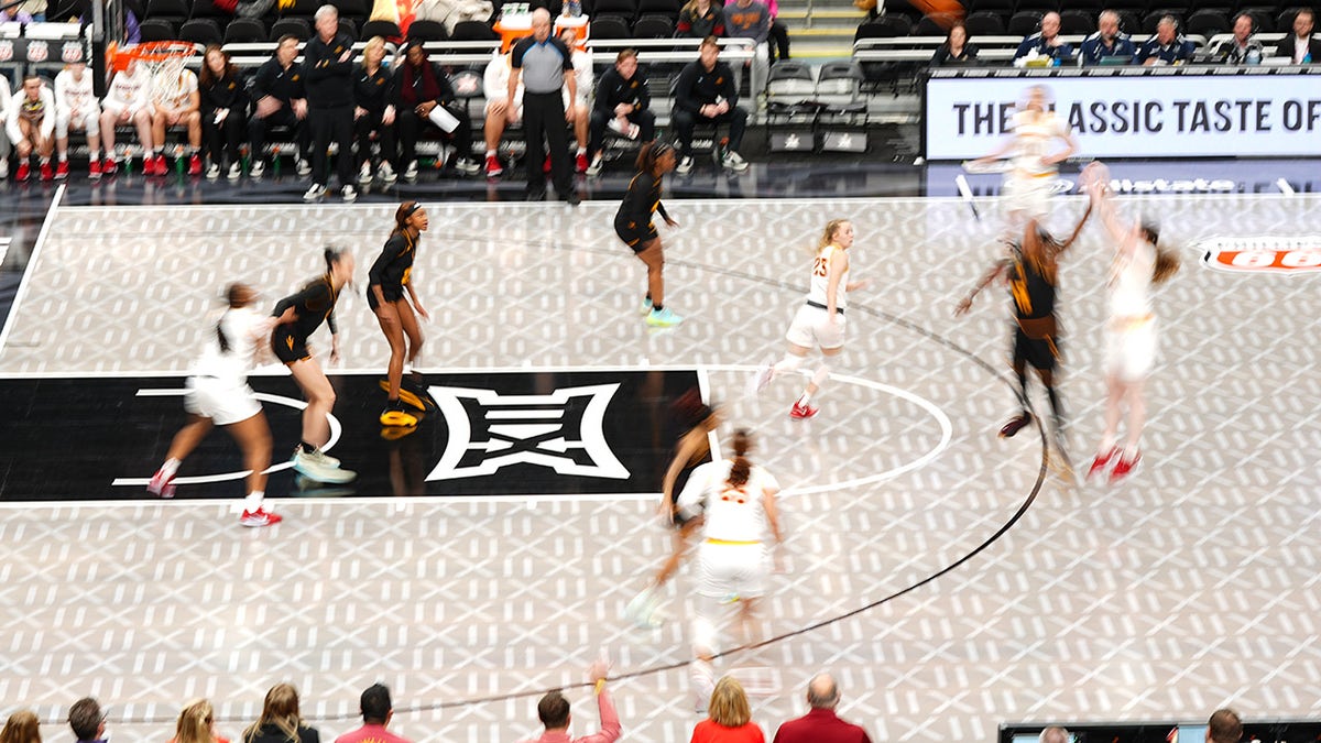 Iowa State and Arizona State players play on court