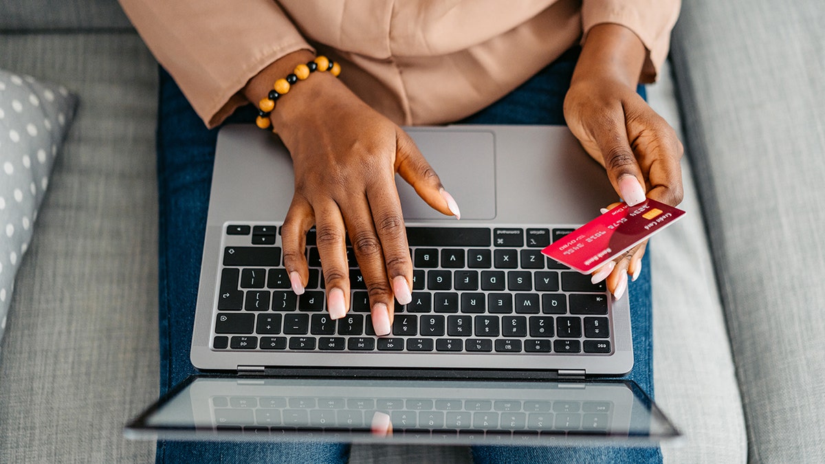 Woman using card to book a hotel