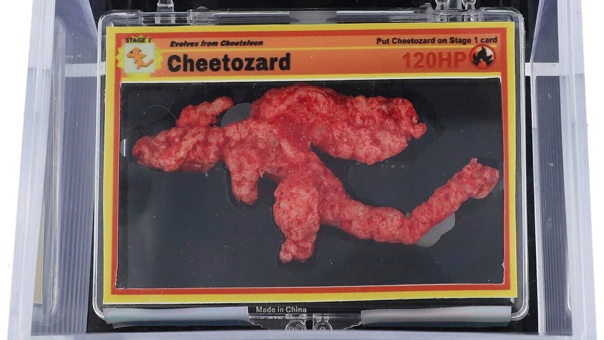 A Pokémon-shaped Cheeto, dubbed "Cheetozard," is shown in a protective case.