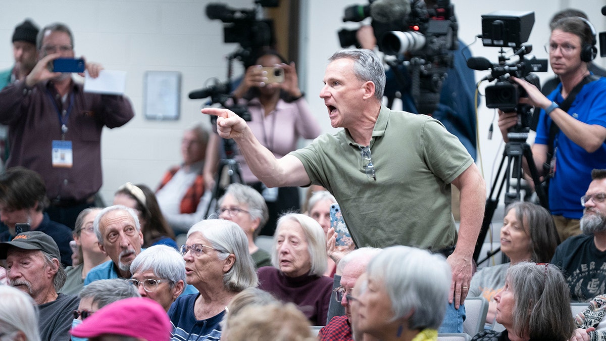 The man screams in MP Chuck Edwards during the city hall event