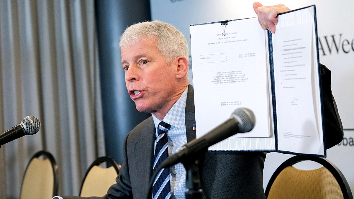 Energy Secretary Chris Wright displays a signed order approving an LNG permit extension for the Delfin LNG project on the Louisiana Coast, during the 2025 CERAWeek by S&P Global conference in Houston on Monday, March 10, 2025.