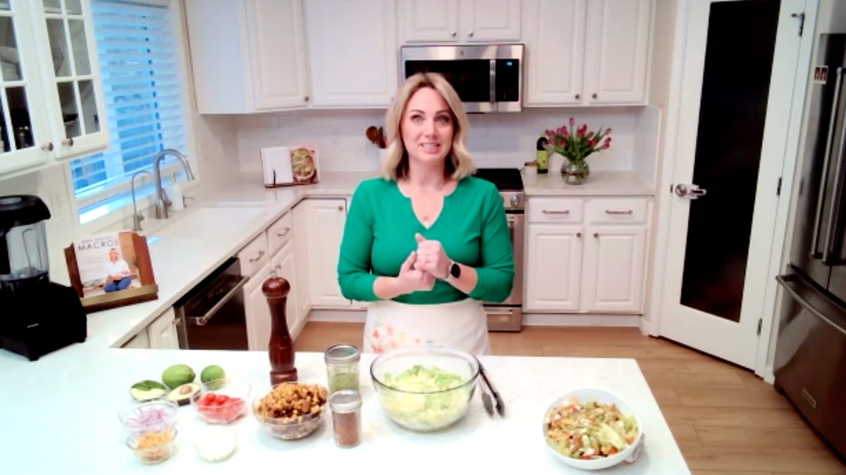 Danielle Lima stands in her kitchen with the ingredients to her zesty chicken salad with cilantro vinaigrette.