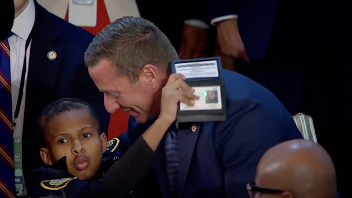 Secret Service Director Sean Curran hugs cancer survivor DJ Daniel, 13, in Washington, D.C.