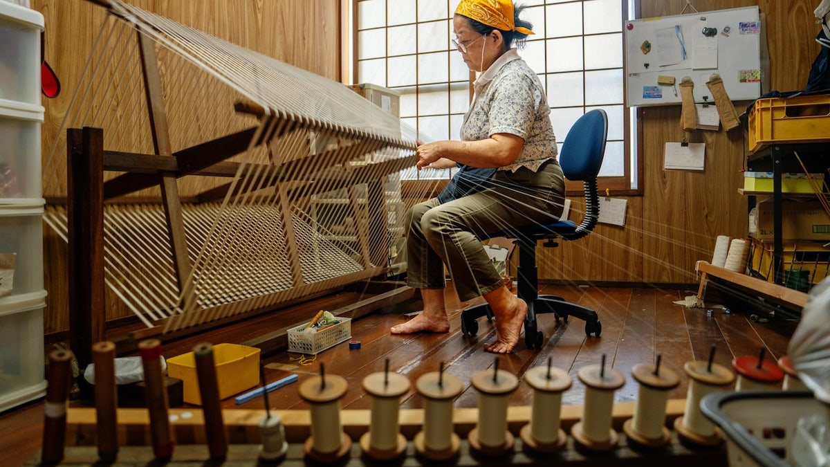 Old woman sewing