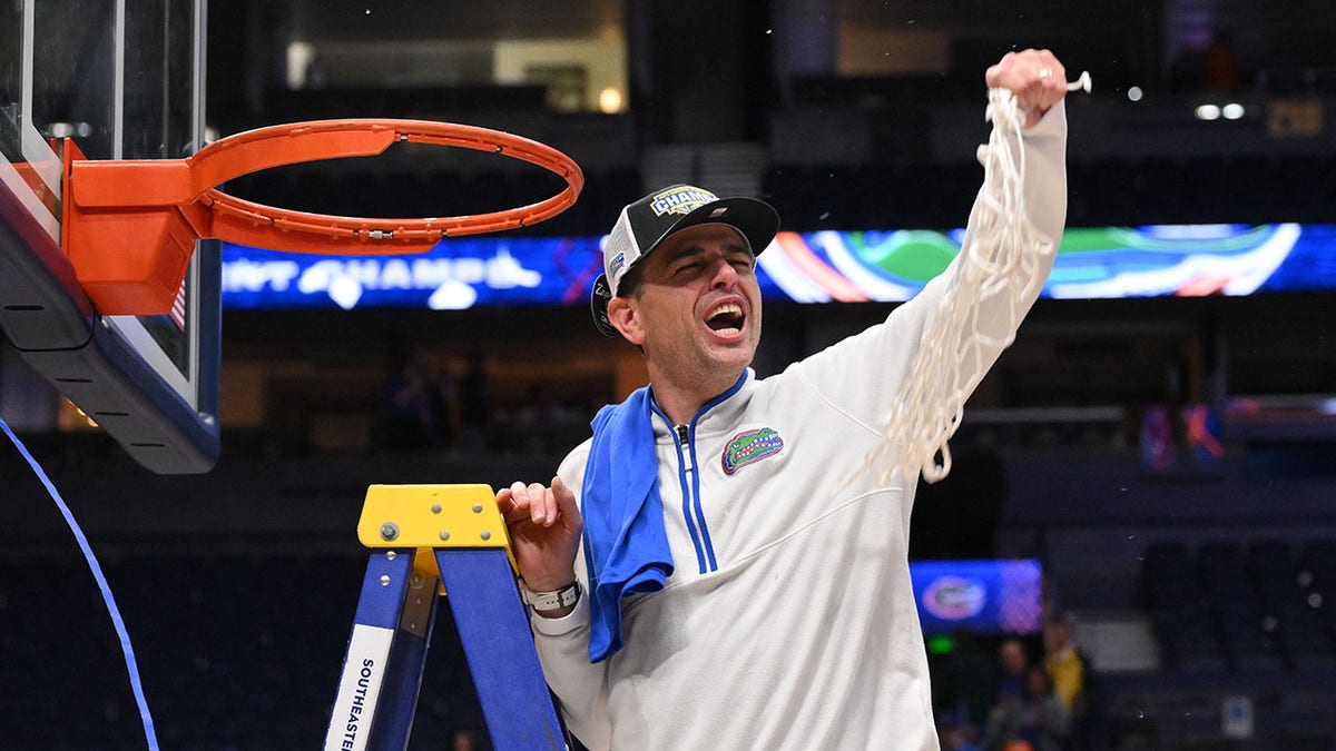 Florida Gators head coach Todd Golden cutting the net after winning SEC Championship Game