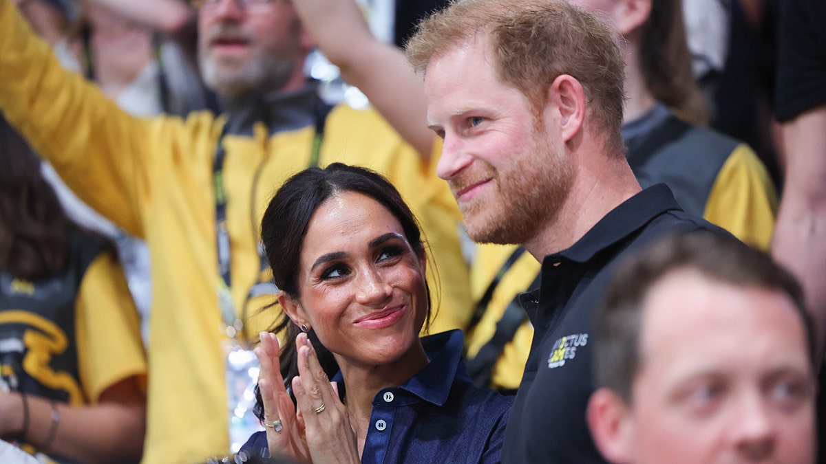 Meghan Markle smiling and looking up at Prince Harry