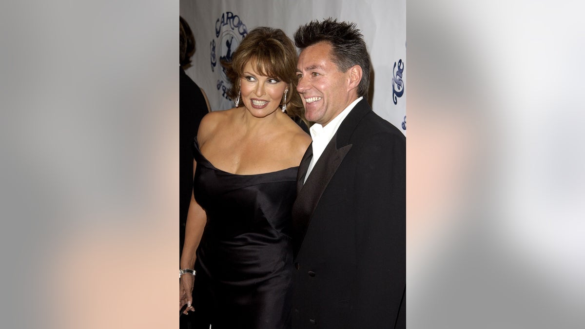 Raquel Welch wearing a low-cut black dress standing alongside her husband in a tux.