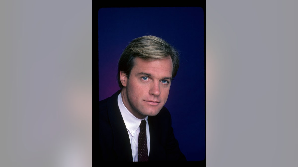 A young Stephen Collins in a black suit and tie.