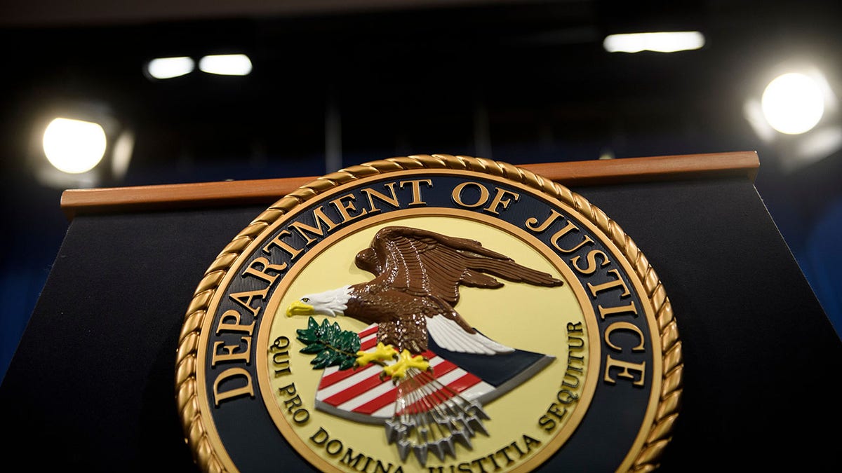 DOJ seal on a podium