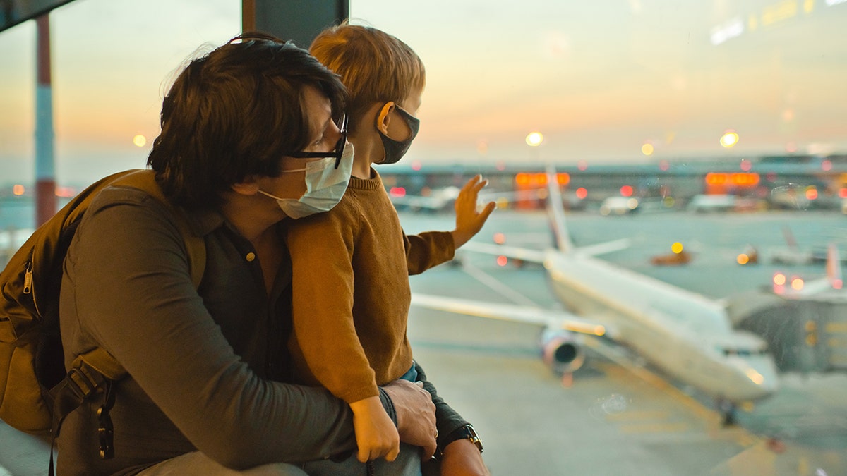 Father and son traveling in an airport