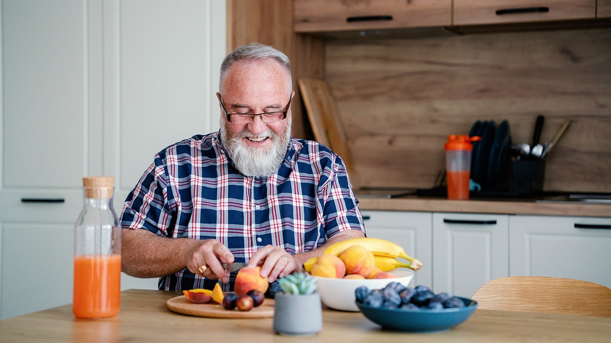 Man eating oranges and orange products.