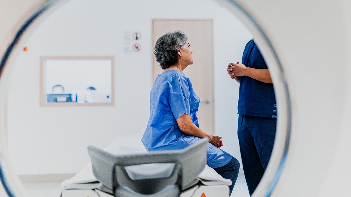 Woman talking to a nurse before a magnetic resonance in the hospital