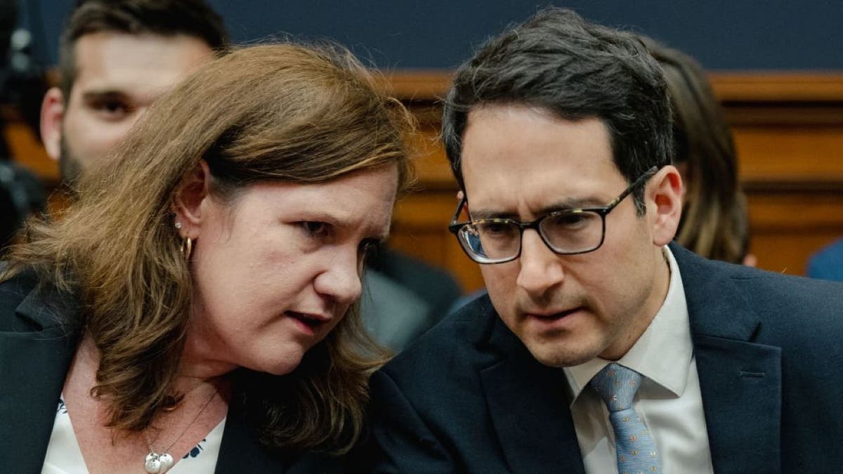 Federal Trade Commission member Rebecca Kelly Slaughter (L) chats with Alvaro Bedoya (R) at FTC Chairman Lina Khan, at a House Judiciary Committee hearing at the House Judiciary Committee at the Rayburn House Office Building in Washington, D.C. on July 13, 2023 at the Rayburn House Office Building in Washington, D.C. on July 13, 2023.